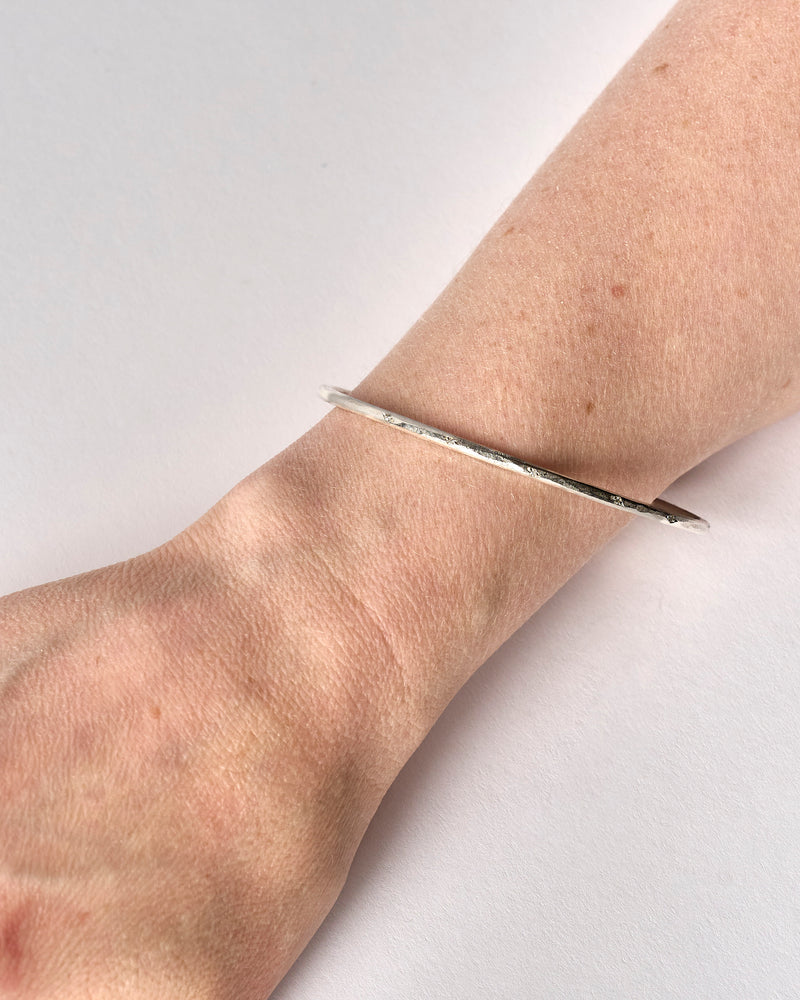 Shimara Carlow —  Hammered Silver Bangle with Scattered Diamonds