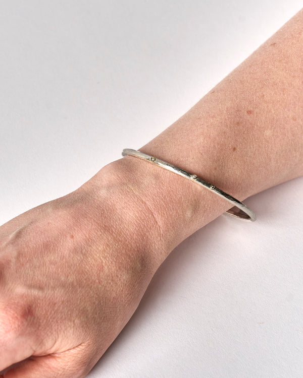 Shimara Carlow —  Hammered Silver Bangle with Diamonds and Gold